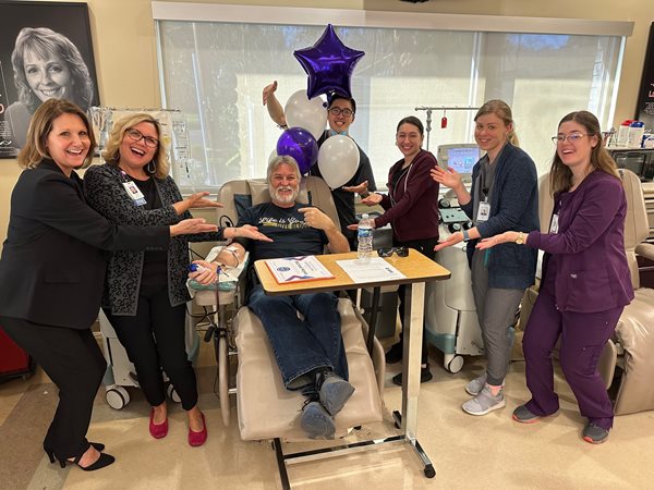 Michael giving blood with Vitalant staff around him