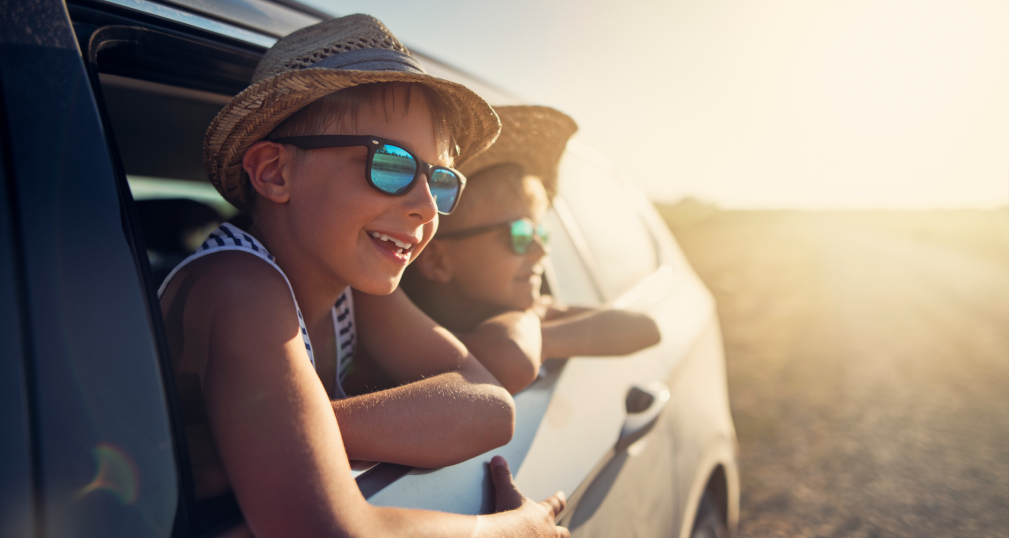 kids hanging out of a car