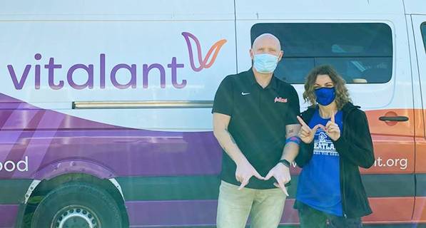 Ryan and Angelia in front of Vitalant blood mobile