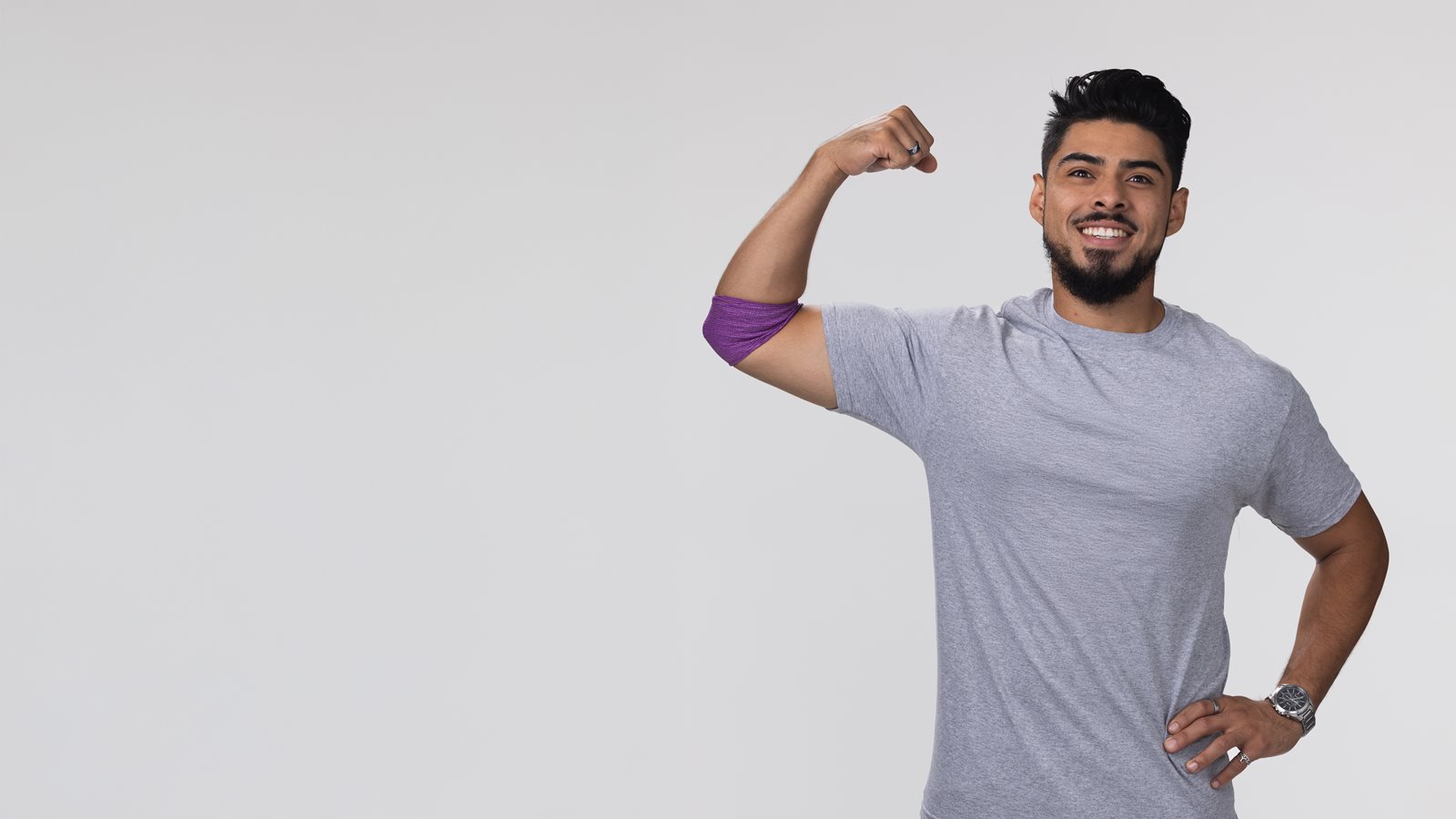 Latino donor flexing arm after giving blood