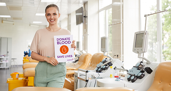 Lady holding a blood donation sign